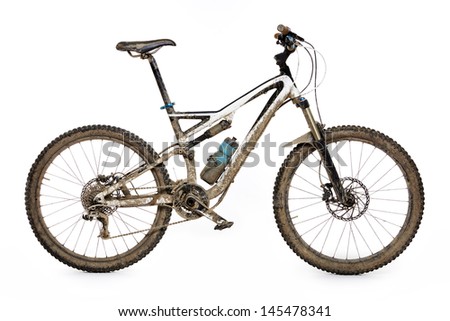 Muddy mountain bike isolated on white background