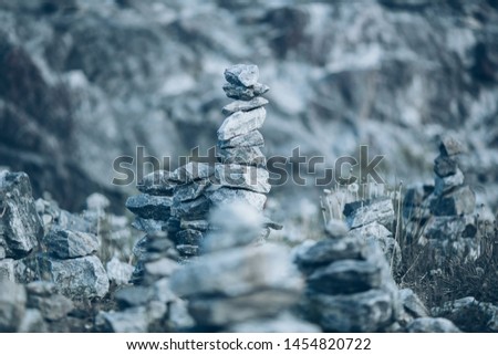 Stone pyramids built by tourists from pieces of marble in the mountain Park Ruskeala, Russia. Image with selective focus and toning