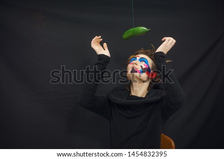 Beautiful girl playing with the big cucumber. Unusual photosession