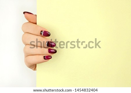 beautiful female hand holding sticker