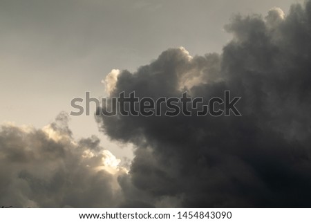 Thunderclouds. The sky after the rain. Beautiful clouds. Dramatic thunderstorm clouds with sun rays.