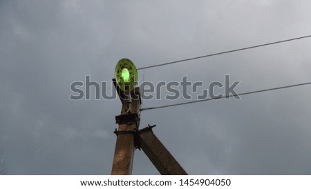 street lamp with wires on the background of gray clouds