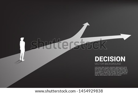 Silhouette of businessman standing at crossroad. Concept of time to make decision in business direction Royalty-Free Stock Photo #1454929838