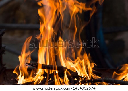 Cool and red flames on a barbecue in Madrid.