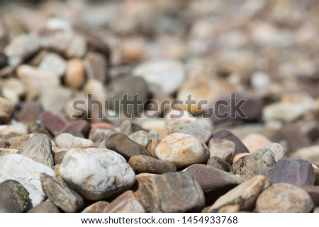 Texture of large river rocks with shallow depth of field in Madrid.