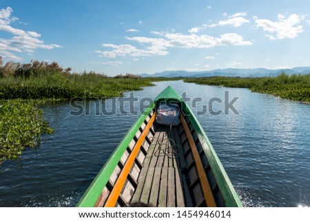 Wide angle picture of tour boat sailing in the middle of nature in Inle Lake, landmark of Myanmar