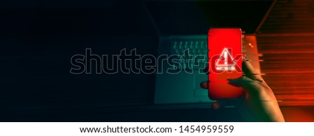 An anonymous hacker and uses a malware with mobile phone to hack password the personal data and money from Bank accounts. The concept of cyber crime. Glitch Royalty-Free Stock Photo #1454959559