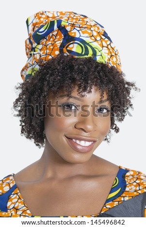 Portrait of an African American woman smiling over gray background