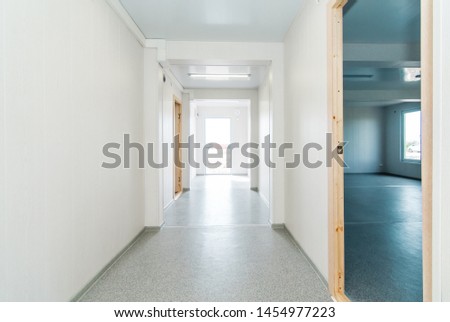 The photo of light white empty office room with bright lighting