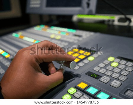 hand on switcher buttons in studio TV station,Television Broadcast.
