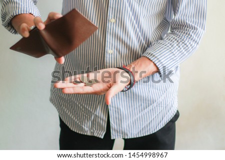 Concept of unemployed. Asian Employees is opening empty wallet. Young Employees is stressed because of no money. Royalty-Free Stock Photo #1454998967