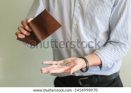 Concept of unemployed. Asian Employees is opening empty wallet. Young Employees is stressed because of no money. Royalty-Free Stock Photo #1454998970
