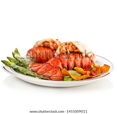 Grilled Lobster Tails Served With Asparagus on white background Royalty-Free Stock Photo #1455009011