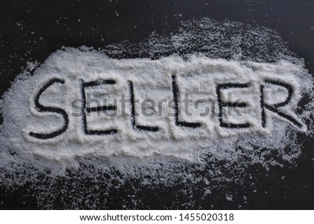 the word "seller" is written in salt on a black board