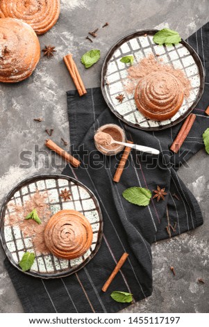 Tasty cinnamon buns on grunge background