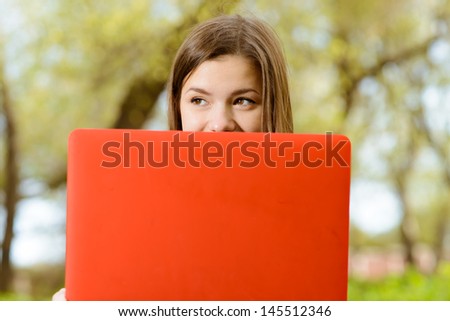 pretty girl with a computer in park