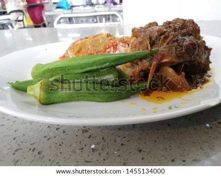 Nasi Kandar. It is a very popular food for the north of the Malaysian peninsula. Some mix curry put together on rice . As in the picture, the nasi kandar are very popular served with goat meat. 