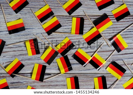 October 3, happy Day of German unity. the concept of patriotism , freedom and independence. Mini flags on wooden background Royalty-Free Stock Photo #1455134246