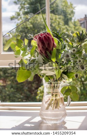 Bunch of Flowers with Protea by Window