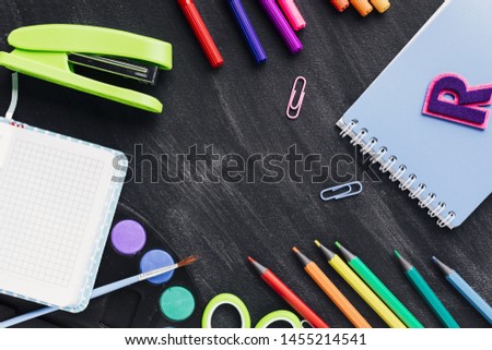Colourful creative stationery on dark background