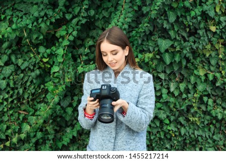 Young female photographer in park