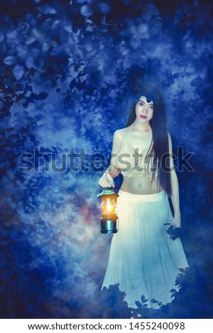 Cute Asian girl wearing a white dress in a mysterious forest. Beautiful girl with lanterns in the forest.