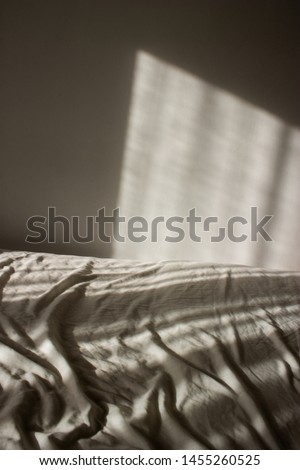 Strong sunlight and wrinkled bed sheets.
