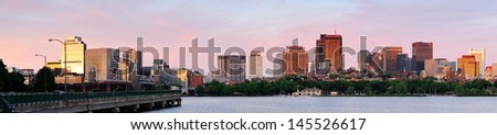 Boston Charles River sunset panorama with urban skyline and skyscrapers with highway bridge.