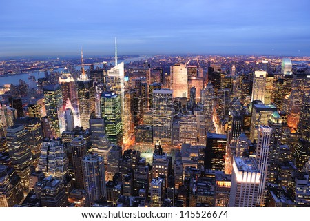New York City Manhattan Times Square night city skyline aerial view with urban skyscraper illuminated.
