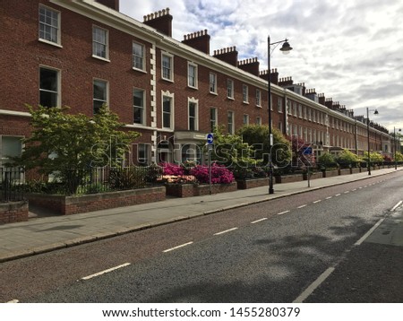 Row of traditional red brick Victorian terraced houses on University Square in Belfast, Northern Ireland