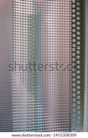 Image of a plastic corner with a grid for reinforcing corners of plaster surfaces.