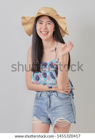 Portrait of a smiling attractive woman wearing hat  in summer on white background