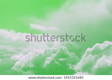 Beautiful background with white clouds and green sky. Copy space. Place for text and design.