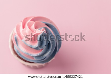 Yummy sweet cupcakes on light pink background