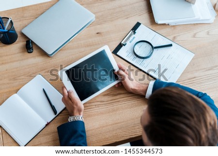 selective focus of recruiter holding digital tablet with blank screen 