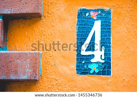 number 4 door sign on orange background