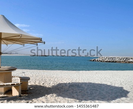 Beach, white sand, blue ocean, sun shade, horizon Royalty-Free Stock Photo #1455361487