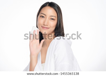 Happy smiling beautiful asian woman using cotton pad cleaning skin