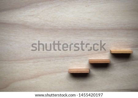 Three wooden steps on a board.(wide steps) Royalty-Free Stock Photo #1455420197