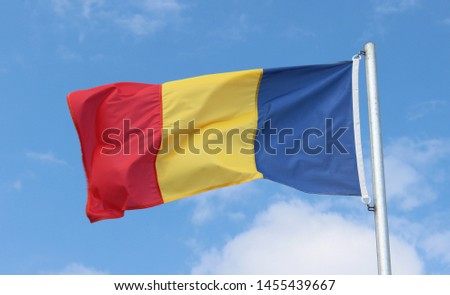 Romanian flag in front of blue sky