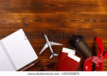 Online travel booking concept. Airplane model and passport on wooden background.- Image 