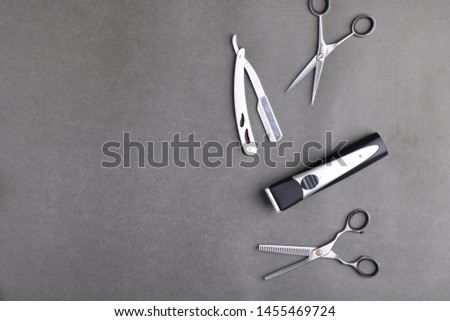 Barber's tools on grey paper. Close up and flat lay. Copy space, black and white photo