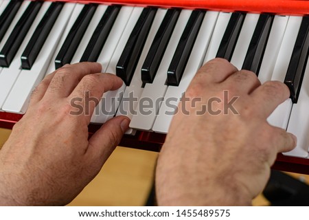 Picture of two hands playing piano