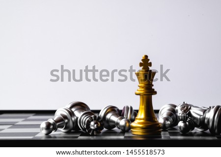 A chess king last stand as a true winner.Money game concept. Copy space. Royalty-Free Stock Photo #1455518573