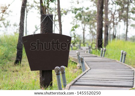 Wooden sign attached to the pole on natural background