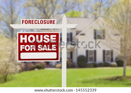 Red Foreclosure Home For Sale Real Estate Sign in Front of House.