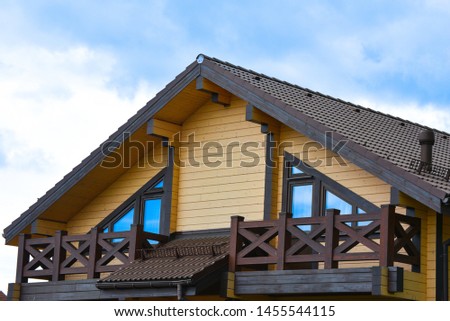 A part of Facade of a beautiful wooden house. Natural photo.