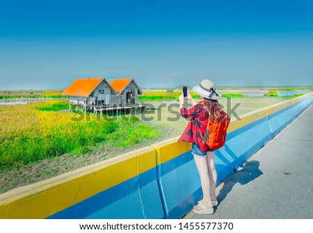 Asian woman take picture of twin house,Phattalung,Thailand
