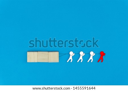 Business leadership and teamwork concept. Leadership help his followers to work tirelessly. Red cartoon character help his team drag a wooden on blue background. Differences between leaders and boss.