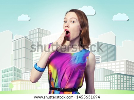 Surprised young female model with red hair. Shocked european woman hiding open mouth behind hand and feeling amazed. Elegant flirty lady in colorful dress and bracelets on background cartoon cityscape